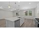 Modern kitchen with island, stainless steel appliances, and pendant lighting at 2191 Gooseberry Way, Longs, SC 29568