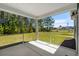 Covered screened-in porch offering views of the backyard and surrounding trees at 2191 Gooseberry Way, Longs, SC 29568