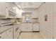 Kitchen featuring white appliances, tile flooring and soft countertops at 25 Gate 1 # 25, Carolina Shores, NC 28467