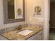 Well-lit bathroom with granite vanity top and framed mirror above the sink at 2519 Southern Crest Dr., Loris, SC 29569