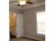 Bedroom view with window, door to the bathroom, and a modern ceiling fan at 2519 Southern Crest Dr., Loris, SC 29569