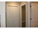 Hallway with neutral paint, closet doors, and clear views to other rooms at 2519 Southern Crest Dr., Loris, SC 29569