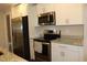Modern kitchen with stainless steel appliances, granite countertops, and white cabinetry at 2519 Southern Crest Dr., Loris, SC 29569