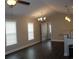Bright living room with hardwood floors, vaulted ceiling, and ample natural light from the windows at 2519 Southern Crest Dr., Loris, SC 29569