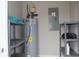 Utility room featuring a water heater, breaker box, and shelving units for storage at 2519 Southern Crest Dr., Loris, SC 29569