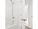 Clean bathroom featuring a bathtub, showerhead, and white door with brass hardware at 2633 Corn Pile Rd., Myrtle Beach, SC 29588