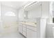 Bright bathroom featuring a dual sink vanity, soaking tub, and a large arched window at 2633 Corn Pile Rd., Myrtle Beach, SC 29588