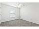 Bright bedroom featuring plush carpeting, a ceiling fan, and a sunny window with blinds at 2633 Corn Pile Rd., Myrtle Beach, SC 29588