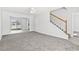 Bright living room with staircase and access to dining area with sliding glass doors at 2633 Corn Pile Rd., Myrtle Beach, SC 29588