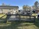 Backyard features a wooden ramp leading to the house, parking spots, a well-maintained lawn, and mature trees at 301 Byrnes Circle, Johnsonville, SC 29555