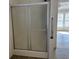 Bathroom featuring a sliding glass door shower with handrail and an open view to the bedroom at 301 Byrnes Circle, Johnsonville, SC 29555