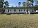 Charming single-story home with a welcoming porch and landscaped front yard at 301 Byrnes Circle, Johnsonville, SC 29555