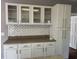 Kitchen with white cabinets, glass door upper cabinets, and subway tile backsplash at 301 Byrnes Circle, Johnsonville, SC 29555