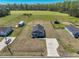 Aerial view of a single-story home, surrounded by lush green fields and mature trees at 3016 Wise Rd., Conway, SC 29526