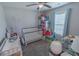 This bedroom features a crib, window, and ceiling fan at 3016 Wise Rd., Conway, SC 29526