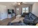 Bright living room with a gray sectional, a white TV stand, and ample natural light at 3016 Wise Rd., Conway, SC 29526