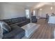 Cozy living room with a gray sectional sofa, modern lighting, and wood-look floors at 3016 Wise Rd., Conway, SC 29526