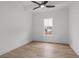 Bright bedroom featuring wood floors, a ceiling fan, and a window with neighborhood views at 311 73Rd Ave. N, Myrtle Beach, SC 29572
