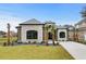 Beautiful two-story home featuring a gray stone facade, well-manicured lawn, and a concrete driveway at 311 73Rd Ave. N, Myrtle Beach, SC 29572