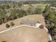 Aerial view of house with surrounding golf course and wooded landscape at 313 Blue Ridge Dr., Pawleys Island, SC 29585