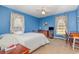 Bedroom with blue walls, ceiling fan, and two windows to bring in natural light at 313 Blue Ridge Dr., Pawleys Island, SC 29585