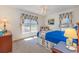 This cozy bedroom is well-lit with large windows and a matching floral motif at 313 Blue Ridge Dr., Pawleys Island, SC 29585