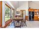 Cozy dining area with a round wood table, chairs, and a large window overlooking the backyard at 313 Blue Ridge Dr., Pawleys Island, SC 29585
