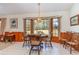 Bright dining area featuring a round table, wood chairs, and a bay window with scenic outdoor views at 313 Blue Ridge Dr., Pawleys Island, SC 29585