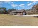 A well-maintained brick home with an attached garage, a lush green lawn, and an inviting driveway at 313 Blue Ridge Dr., Pawleys Island, SC 29585