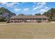 A charming single-story brick home with a well-manicured lawn and inviting curb appeal in a sunny day at 313 Blue Ridge Dr., Pawleys Island, SC 29585