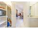 Hallway leading to a living room with brick fireplace, and a bathroom with white sink at 313 Blue Ridge Dr., Pawleys Island, SC 29585