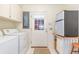Functional laundry room with washer, dryer, and storage cabinets adjacent to the door to the outside at 313 Blue Ridge Dr., Pawleys Island, SC 29585