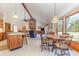 Open concept living and dining area with a brick fireplace, vaulted ceilings, and natural light at 313 Blue Ridge Dr., Pawleys Island, SC 29585