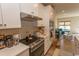 Modern kitchen featuring stainless steel appliances, white cabinets, and an open view to the living area at 341 Golan Circle # B, Myrtle Beach, SC 29579