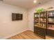 Well-lit living room featuring a mounted television and a stylish display cabinet with sleek lines at 341 Golan Circle # B, Myrtle Beach, SC 29579