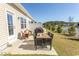 Cozy patio with table, chairs, and grill, perfect for enjoying outdoor meals and a view of the water at 341 Golan Circle # B, Myrtle Beach, SC 29579
