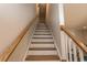 A stairway features light beige walls and wood handrails leading to the upper level of the home at 341 Golan Circle # B, Myrtle Beach, SC 29579
