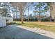 Expansive backyard with a stone patio, lush lawn, and mature trees at 3494 Cactus St. # 3494, Myrtle Beach, SC 29577