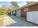 Home's exterior featuring a brick facade, a sliding door, a small patio and fenced in backyard at 3494 Cactus St. # 3494, Myrtle Beach, SC 29577