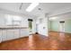 Functional kitchen with white cabinetry, tiled floor and an open view to the living area at 3494 Cactus St. # 3494, Myrtle Beach, SC 29577