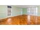 Living room featuring parquet floors, a door to the exterior, and soft green walls at 3494 Cactus St. # 3494, Myrtle Beach, SC 29577