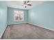 Neutral bedroom features plush carpeting, a ceiling fan, and a window that provides ample natural light at 351 Firenze Loop, Myrtle Beach, SC 29579