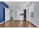 This is a bedroom with light blue walls and hardwood floors with an opened closet with adjustable shelving at 351 Firenze Loop, Myrtle Beach, SC 29579