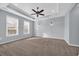 Spacious bedroom featuring plush carpeting, a ceiling fan, and two large windows at 351 Firenze Loop, Myrtle Beach, SC 29579
