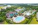 Aerial view of a community pool with seating areas, palm trees, and lush landscaping at 351 Firenze Loop, Myrtle Beach, SC 29579