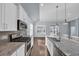 Modern kitchen featuring stainless steel appliances, granite countertops, and a spacious island with a sink at 351 Firenze Loop, Myrtle Beach, SC 29579