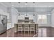 Open kitchen design showcasing a central island with stone accents, pendant lighting, and bar stool seating at 351 Firenze Loop, Myrtle Beach, SC 29579