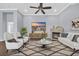 Bright living room featuring a stone fireplace, modern furnishings, and a ceiling fan at 351 Firenze Loop, Myrtle Beach, SC 29579