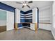 This home office has custom shelves and hardwood floors with a ceiling fan at 351 Firenze Loop, Myrtle Beach, SC 29579