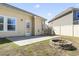 The backyard with a stone fire pit and a partial view of the adjacent house at 3659 White Wing Circle, Myrtle Beach, SC 29579